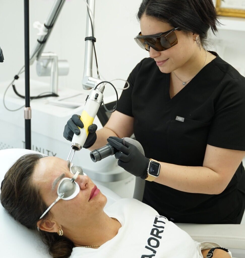 Tattoo removal specialist using advanced laser technology during a treatment session at BH Laser Tattoo Removal
